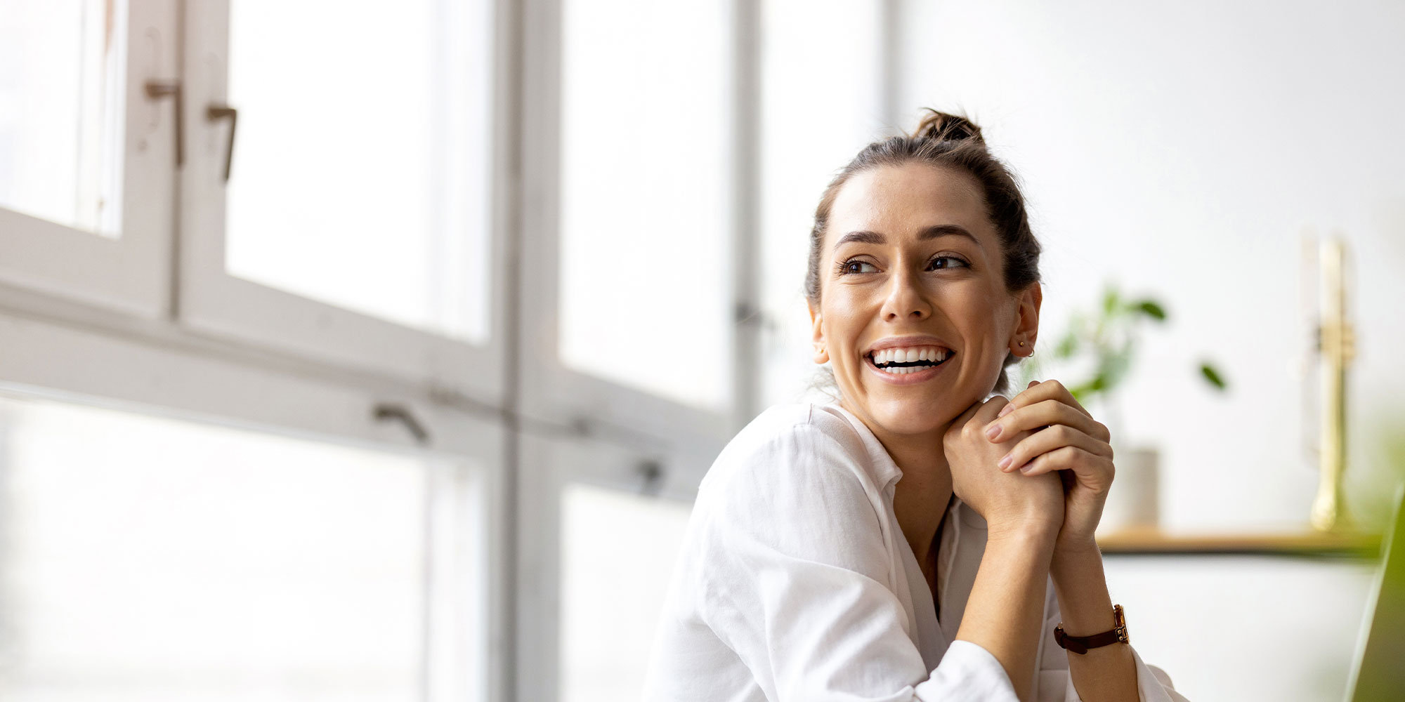 person smiling on the comfort of their own home