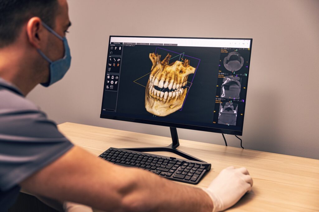 Prosthodontist evaluating dental implant candidacy with a patient in Fullerton, CA using 3D imaging