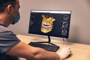 Prosthodontist evaluating dental implant candidacy with a patient in Fullerton, CA using 3D imaging