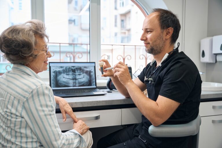 Senior patient consulting with Dr. Joon Park about dental implants in Fullerton CA